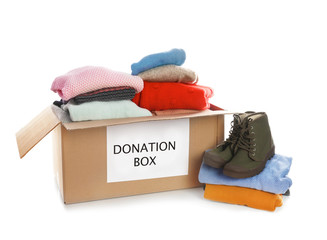 Wall Mural - Donation box, shoes and clothes on white background