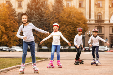 happy children roller skating on city street