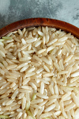 Organic brown rice in wooden bowl.