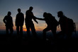 © Eugene - A group of tourists on top of a mountain at sunset.