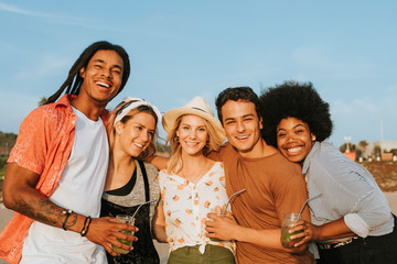 Wall Mural - Group of diverse friends hanging out at the beach