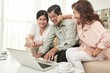 © DragonImages - Laughing old friends watching funny videos on laptop at home