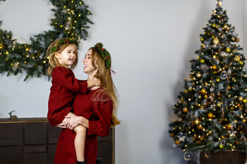 beautiful family, mother plays with her daughter in the new year