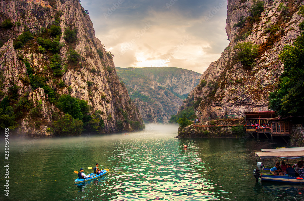Obraz na płótnie Canyon Matka near Skopje with people kayaking and amazing foggy scenery w salonie