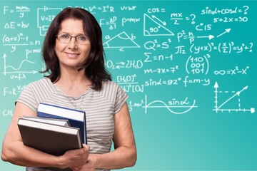 Wall Mural - Mature woman teacher with books on background