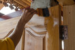 carpenter s hands paintbrush varnish  to wood door