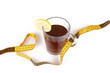 © Riko Best - Slimming with tea, cup with tea and measuring tape isolated on white background