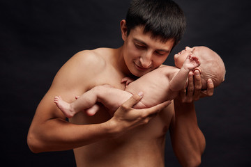 Wall Mural - cheerful man cannot understand that he has become a dad. unbelievable, happy moments.man is listening the heart of the baby