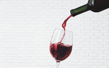 Wall Mural - Red wine pouring in glass