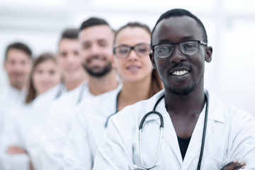 Wall Mural - Team of smiling professional doctors standing together