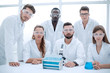 © ASDF - Group of scientists with gowns in laboratory