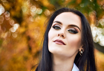 Hot white brunette in an autumn forest