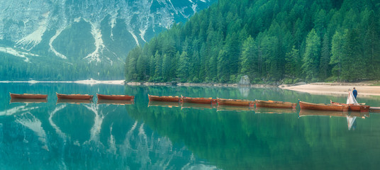 Bride and groom on lake di Braies, Italy