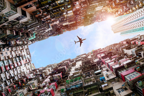 Plane Flying Over Crowded Houses in Quarry Bay, Hong Kong Canvas Print