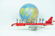 Miniature backpacker with airplane and globe,tourist concept