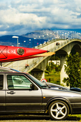 Wall Mural - Car with canoes on top roof in mountains