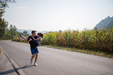 Fototapeta  - happy couple jogging along a country road