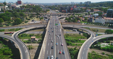 Traffic intersection. Road, cars, trucks. Camera high above the road.