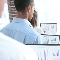 rear view.business colleagues holding folders with financial data