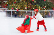 © famveldman - Kids ice skating in winter. Ice skates for child.