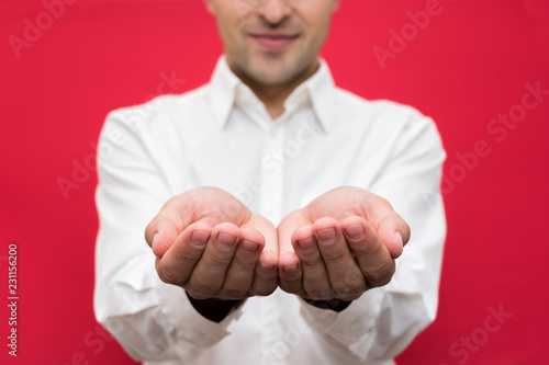 Attractive Guy With Outstretched Arms On Camera Front View Bright Red Background Close Up Stock Photo Adobe Stock