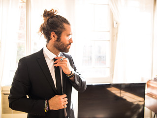 young man with long hair wearing a suit