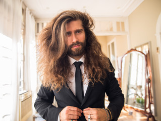 Wall Mural - young man with long hair wearing a suit