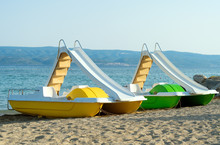 Pedal-boats With Water Slides On The Beach.
