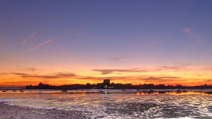 Portchester Castle and creek in an autumn colourful sunset, Hampshire, UK