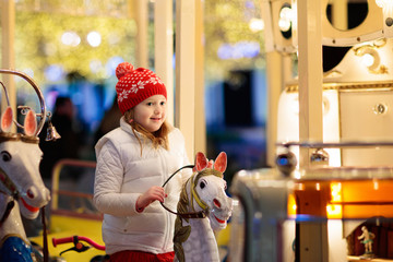 Kids at Christmas fair. Child at Xmas market.