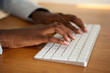 © mimagephotos - Close up female hands typing on computer keyboard