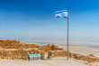 Flag of Israel with blue Star of David and view of dead Sea and Jordan from the top of Masada, Israel.