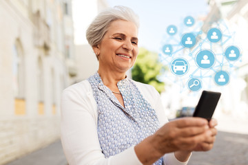 Poster - technology, people and transportation concept - happy senior woman with smartphone and car sharing icons on street in summer