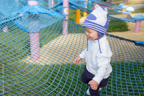 Cute Little Asian 2 Years Old Toddler Baby Boy Child Having Fun Cute Little Asian 2 Years Old Toddler Baby Boy Child Having Fun Trying To Climb On