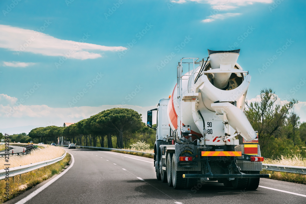 Concrete Transport Truck In-transit Mixer Unit In Motion On Coun - obrazy, fototapety, plakaty 