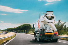 Concrete Transport Truck In-transit Mixer Unit In Motion On Coun