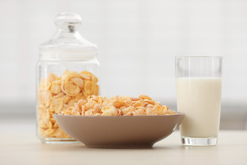 Sticker - Cornflakes with glass of milk on kitchen table