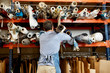 © Stocksy - Worker Removing Rolled Up Fabric From Shelf At Sofa Workshop