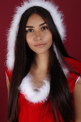 Beautiful young woman wearing santa claus costume