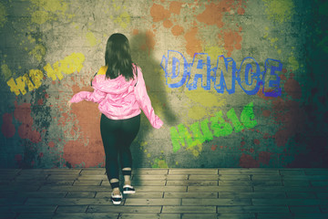 Wall Mural - Female hip-hop dancer dancing with sweatshirt