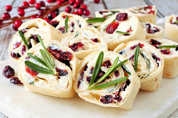 Cranberry, cream cheese pinwheel appetizers. Holiday food concept. Close up, on a white background.