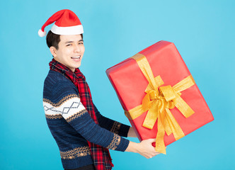 happy Young man holding Christmas gift box