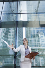 Wall Mural - Young businesswoman throwing files in the air.