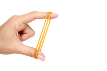 Yellow Rubber Bands Close Up With Hand Isolated On White Background, Copy Space Template.