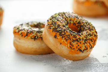 Wall Mural - Orange Donut with sprinkles on white background