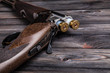 © solidmaks - open hunting rifle on a wooden background