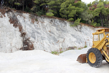 Stone mine wall and dust with loader