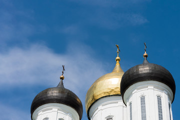 Domes of a temple on the background of a blue sky