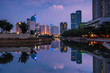 Beautiful Jakarta city in sunset. Landscape of office building and business center of capital city  Jakarta reflected on water in the evening
