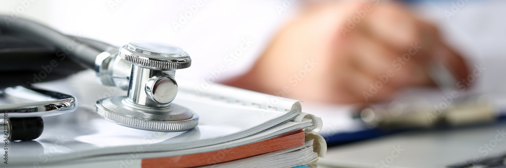 Stethoscope head lying on medical forms closeup - obrazy, fototapety, plakaty 